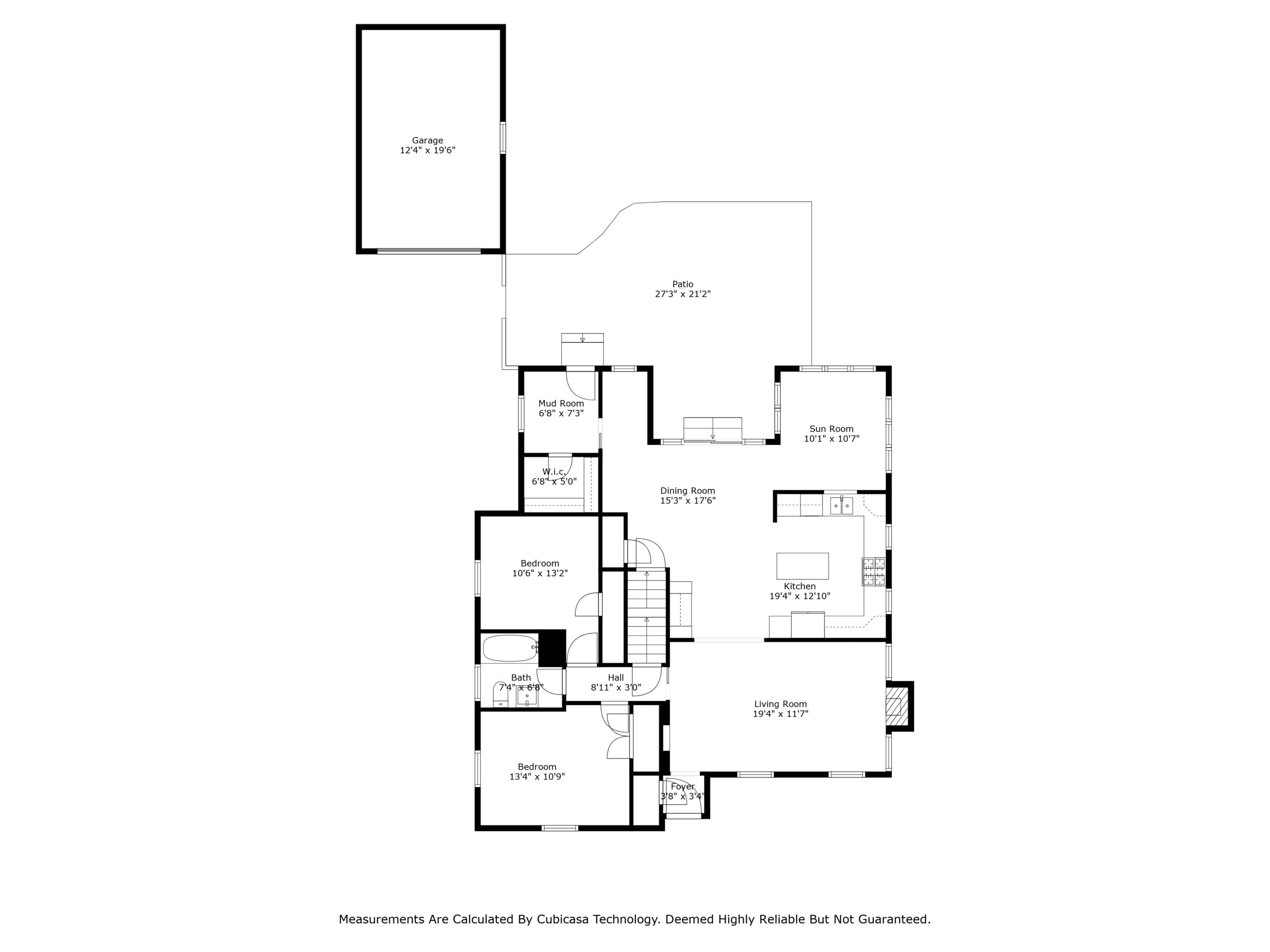 Black and white floor plan of a house featuring a garage, patio, two bedrooms, two bathrooms, kitchen, dining room, living room, laundry room, and closets. Room dimensions are labeled. Measurements disclaimer at bottom.