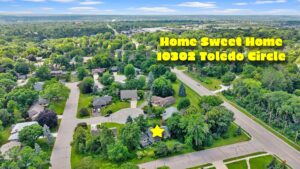Aerial view of a suburban neighborhood with trees and houses. Text reads Home Sweet Home 10302 Toledo Circle. A yellow star marks one house.